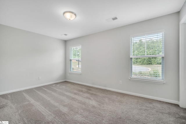 unfurnished room with baseboards and carpet