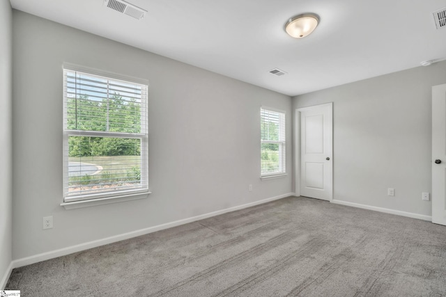 carpeted spare room with baseboards