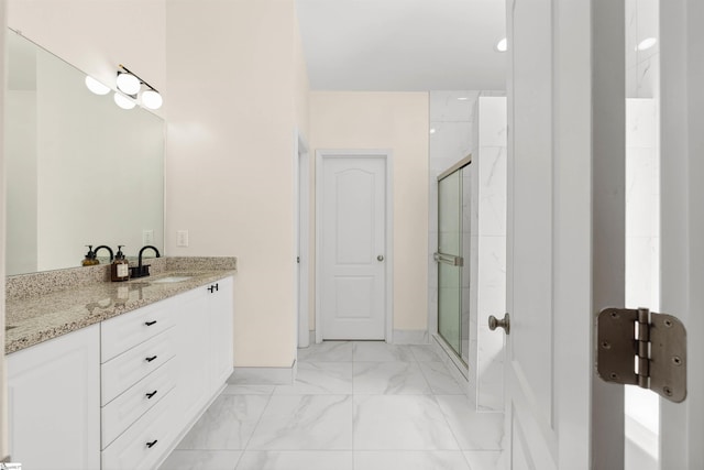 bathroom featuring a stall shower, marble finish floors, vanity, and baseboards
