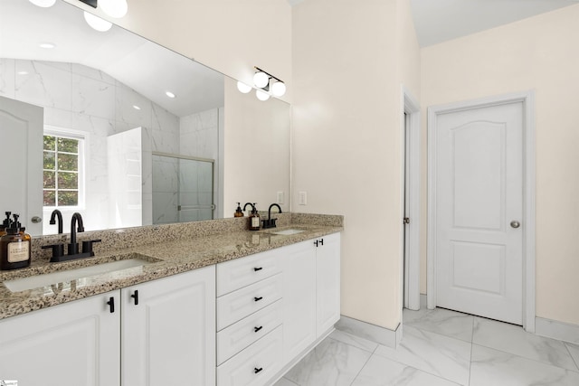bathroom with a shower stall, marble finish flooring, double vanity, and baseboards