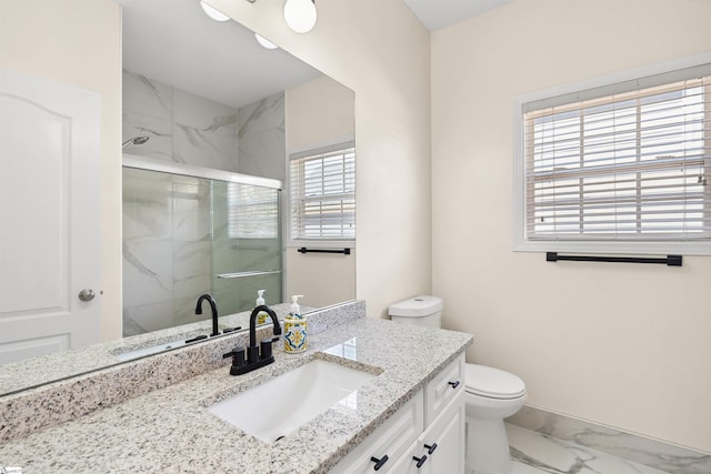 full bath featuring marble finish floors, a marble finish shower, toilet, vanity, and baseboards