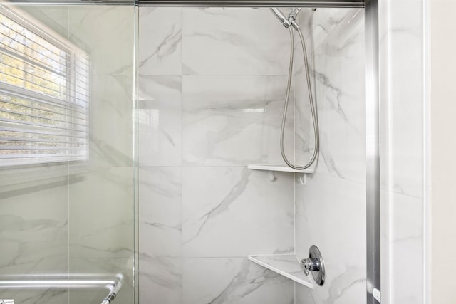 bathroom with a marble finish shower