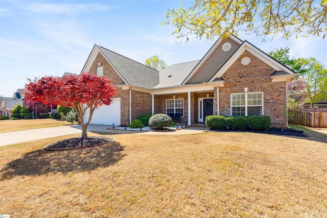 traditional-style home featuring driveway, brick siding, covered porch, a garage, and roof with shingles