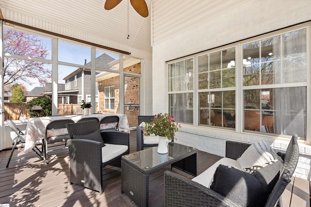 sunroom featuring ceiling fan