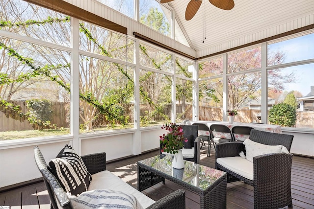 sunroom / solarium featuring ceiling fan, an outdoor living space, plenty of natural light, and lofted ceiling