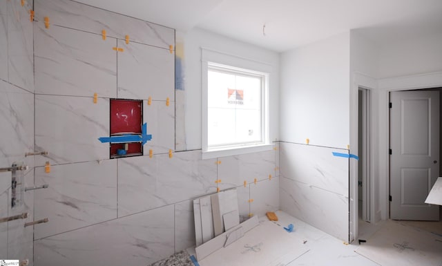 bathroom with a marble finish shower