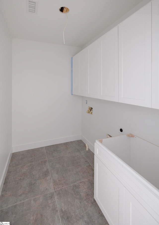 washroom featuring cabinet space, hookup for a washing machine, baseboards, and electric dryer hookup