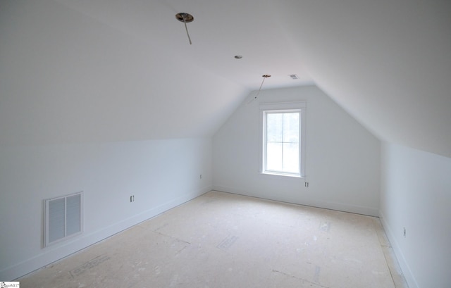 bonus room with vaulted ceiling and baseboards