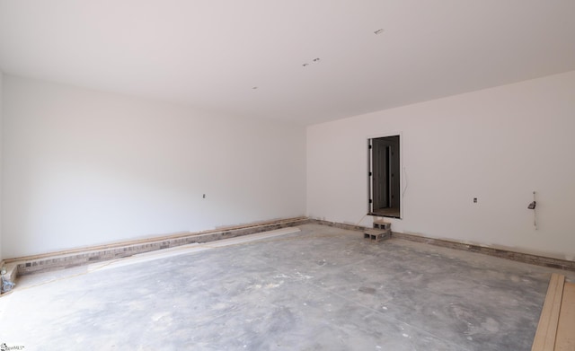 spare room with unfinished concrete floors