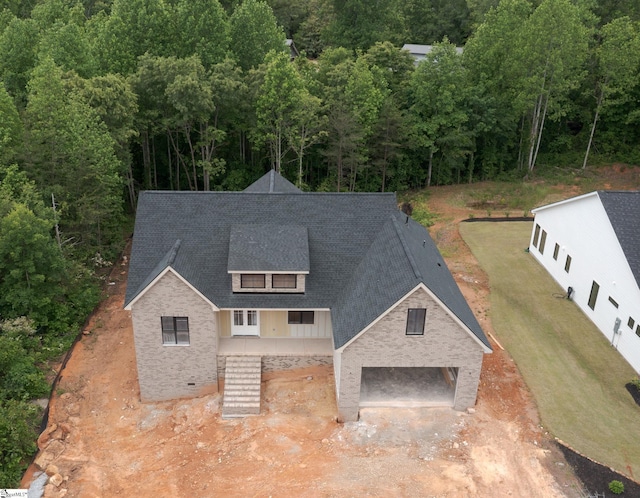 view of subject property with a heavily wooded area