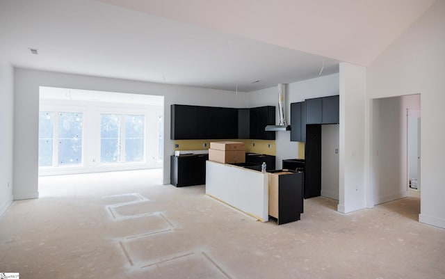 kitchen with dark cabinets, a center island, and baseboards
