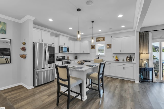 110 Strongridge Trl, Simpsonville, SC 29681 - kitchen featuring appliances with stainless steel finishes, recessed lighting, plenty of natural light, white cabinetry, and crown molding