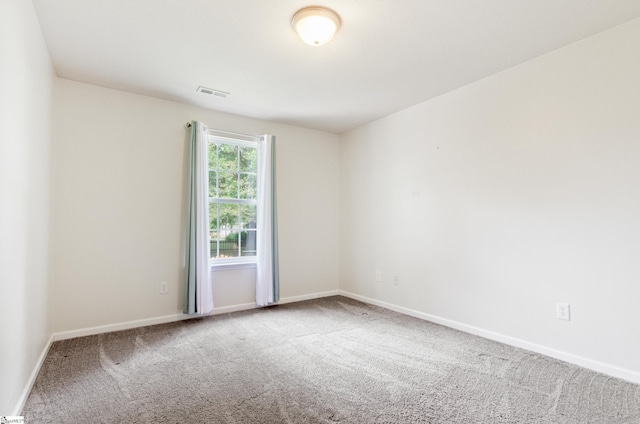 unfurnished room featuring carpet flooring and baseboards