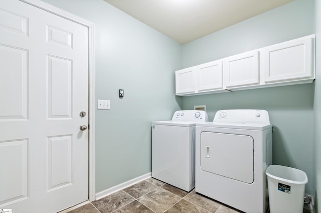 laundry room with cabinet space, separate washer and dryer, and baseboards