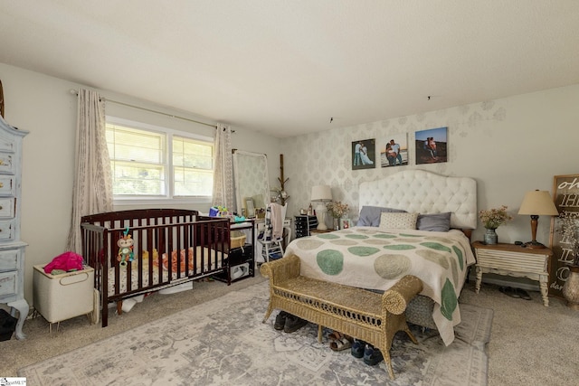 bedroom with carpet floors and wallpapered walls