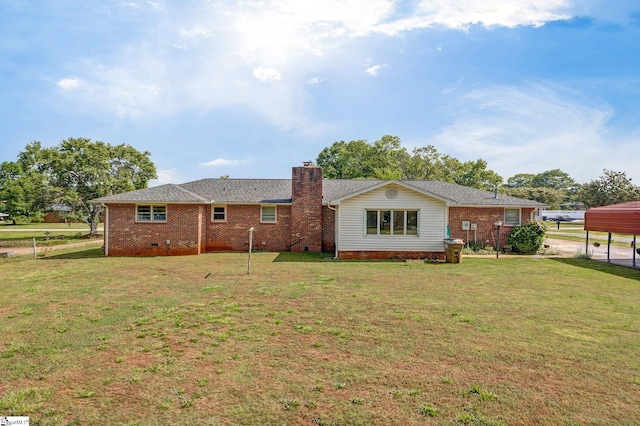 rear view of house with a yard, a chimney, and brick siding
