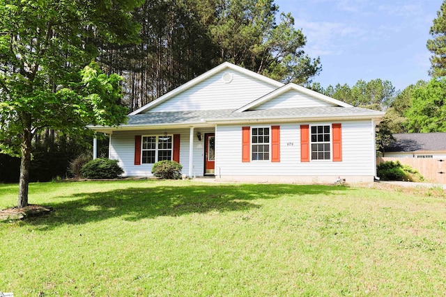 view of front facade featuring a front lawn and a shingled roof