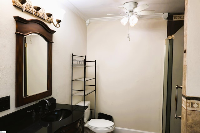 bathroom with ceiling fan, ornamental molding, toilet, vanity, and a shower with shower door