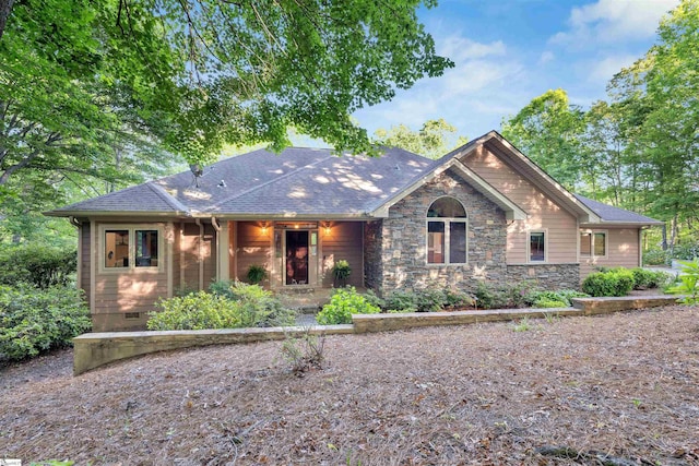 view of front of house with stone siding and a shingled roof
