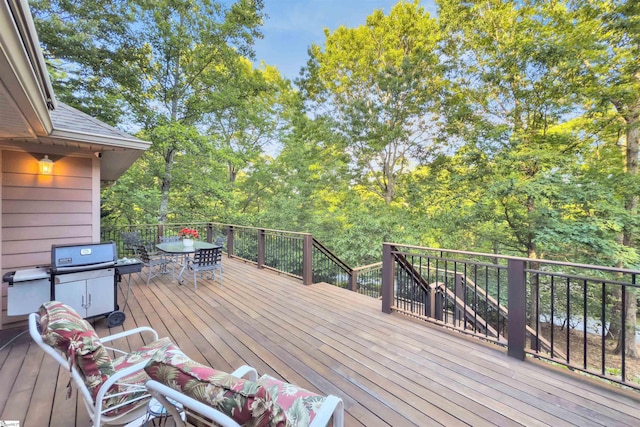 deck featuring a grill and outdoor dining area
