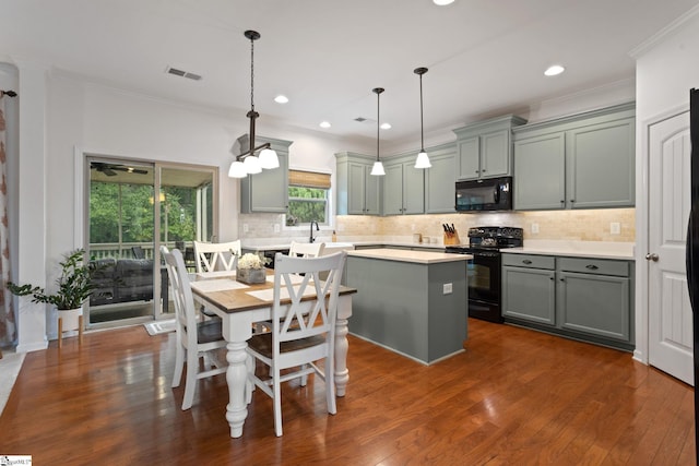 kitchen featuring black appliances, light countertops, gray cabinetry, backsplash, and ornamental molding