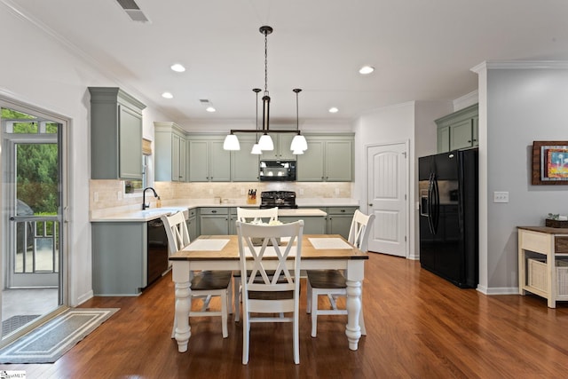 dining room with dark wood-type flooring, crown molding, and recessed lighting