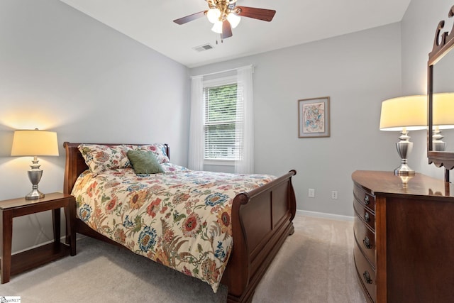 bedroom featuring light carpet, baseboards, and ceiling fan