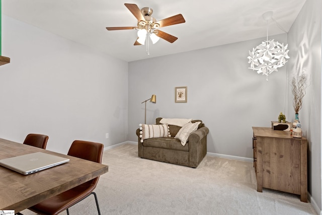 office space featuring light colored carpet, baseboards, and ceiling fan