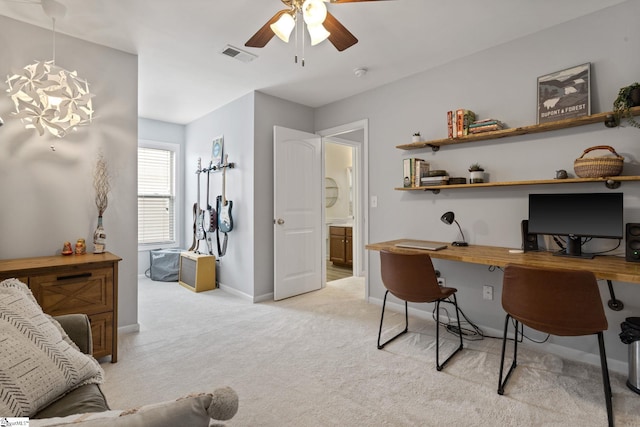 office featuring light carpet, ceiling fan, and baseboards