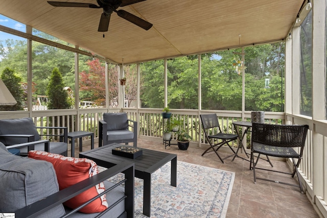 sunroom / solarium featuring a ceiling fan and outdoor lounge area
