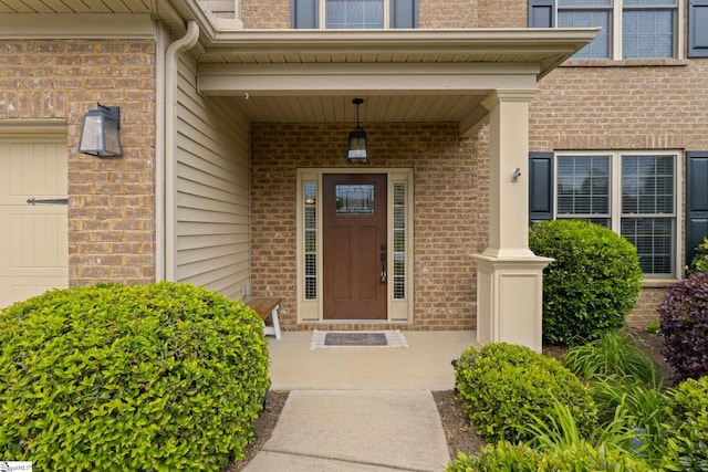 property entrance featuring brick siding