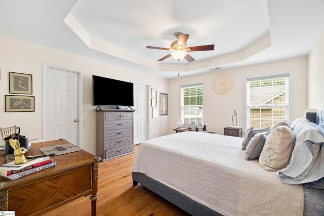 111 Woodvale Ave, Fountain Inn, SC 29644 - bedroom with a tray ceiling, light wood-type flooring, and ceiling fan
