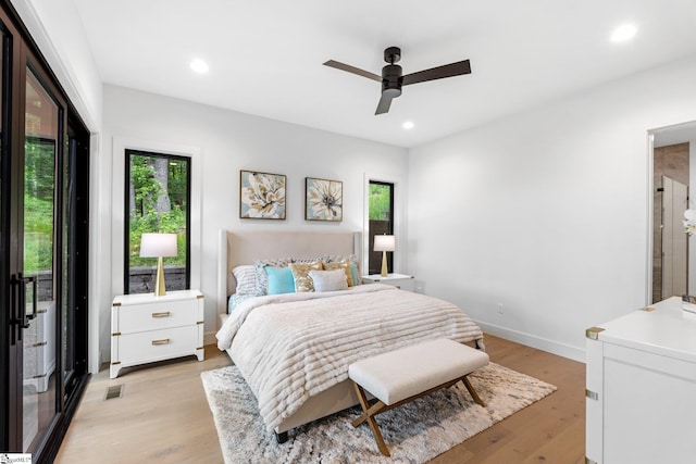 bedroom featuring multiple windows, light wood-style flooring, recessed lighting, ceiling fan, and baseboards
