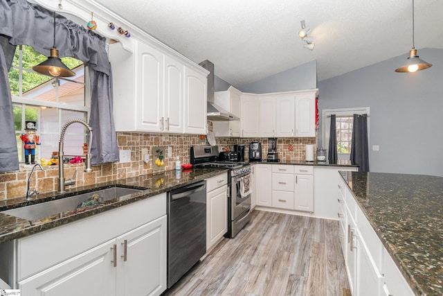 202 Forest Dr, Liberty, SC 29657 - kitchen featuring appliances with stainless steel finishes, wall chimney range hood, a sink, lofted ceiling, and decorative backsplash