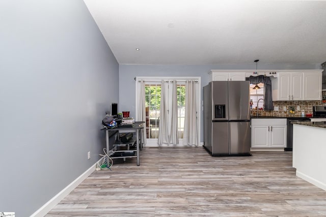 202 Forest Dr, Liberty, SC 29657 - kitchen with stainless steel appliances, white cabinets, light wood-style floors, and tasteful backsplash