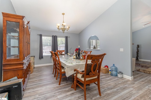 202 Forest Dr, Liberty, SC 29657 - dining area featuring a chandelier, vaulted ceiling, light wood-style flooring, and baseboards