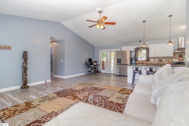 202 Forest Dr, Liberty, SC 29657 - living room featuring a ceiling fan, lofted ceiling, light wood-style floors, baseboards, and french doors