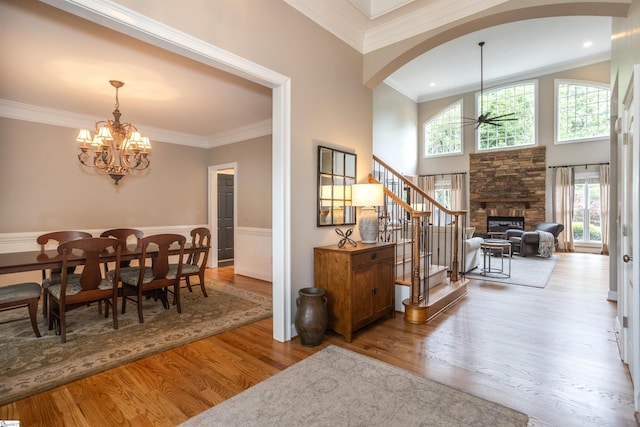 5 Marlis Ct, Greer, SC 29650 - dining room with arched walkways, wood finished floors, a chandelier, ornamental molding, and a fireplace
