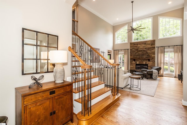 5 Marlis Ct, Greer, SC 29650 - staircase with a ceiling fan, a high ceiling, wood finished floors, a stone fireplace, and ornamental molding