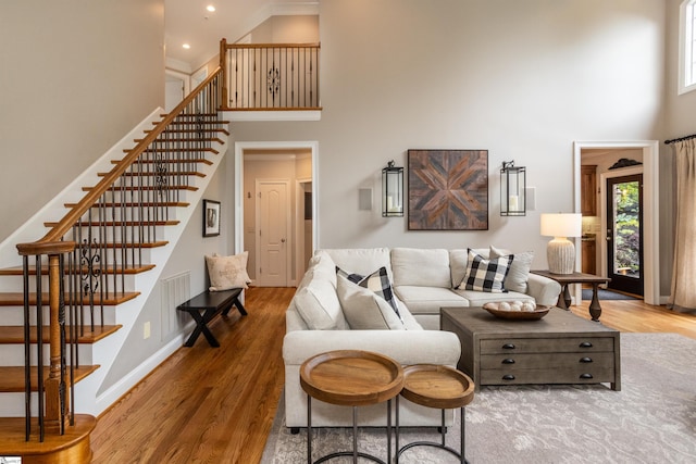 5 Marlis Ct, Greer, SC 29650 - living room with a towering ceiling, healthy amount of natural light, stairway, wood finished floors, and baseboards