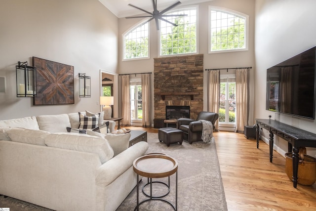 5 Marlis Ct, Greer, SC 29650 - living area with a high ceiling, ceiling fan, light wood-type flooring, a fireplace, and crown molding
