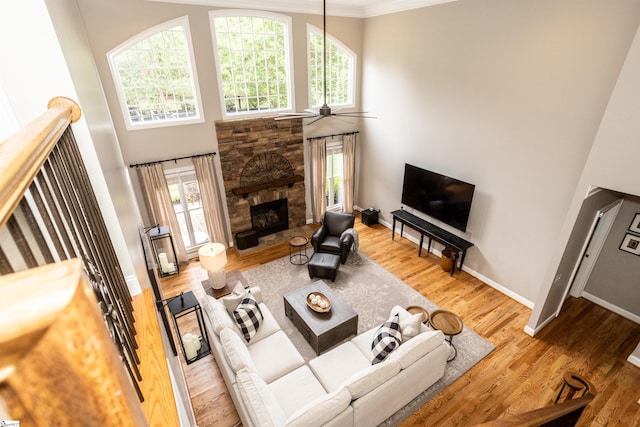5 Marlis Ct, Greer, SC 29650 - living area with a ceiling fan, a high ceiling, ornamental molding, a stone fireplace, and wood finished floors