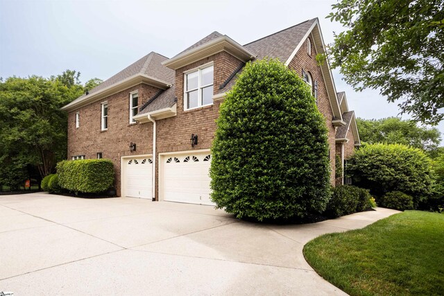5 Marlis Ct, Greer, SC 29650 - view of home's exterior featuring brick siding, driveway, a garage, and roof with shingles
