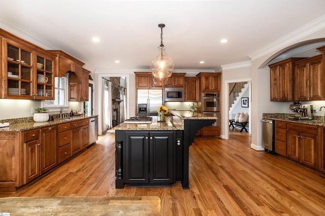 5 Marlis Ct, Greer, SC 29650 - kitchen with built in appliances, a kitchen island, glass insert cabinets, decorative light fixtures, and light stone counters