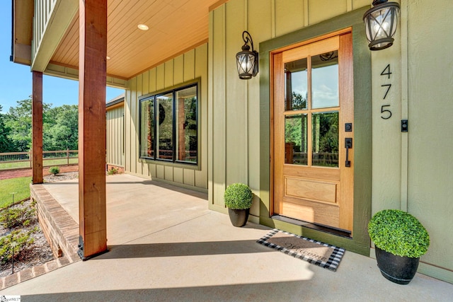 475 Johnson Rd, Easley, SC 29642 - view of exterior entry featuring board and batten siding, fence, and covered porch
