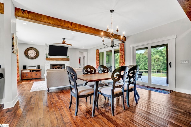 475 Johnson Rd, Easley, SC 29642 - dining room featuring a stone fireplace, a ceiling fan, dark wood-type flooring, a chandelier, and beam ceiling