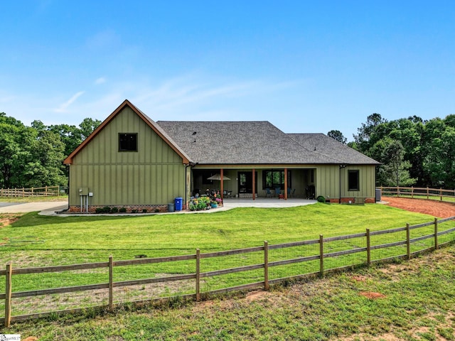 475 Johnson Rd, Easley, SC 29642 - back of house with board and batten siding, a patio, and roof with shingles