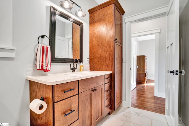 475 Johnson Rd, Easley, SC 29642 - bathroom featuring marble look tiles, backsplash, vanity, and baseboards