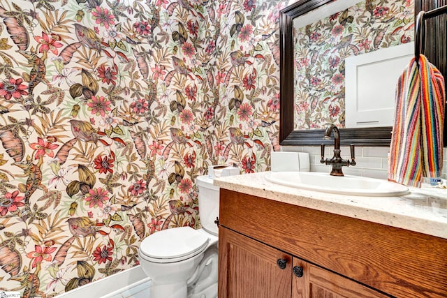 475 Johnson Rd, Easley, SC 29642 - bathroom featuring wallpapered walls, toilet, vanity, tasteful backsplash, and baseboards