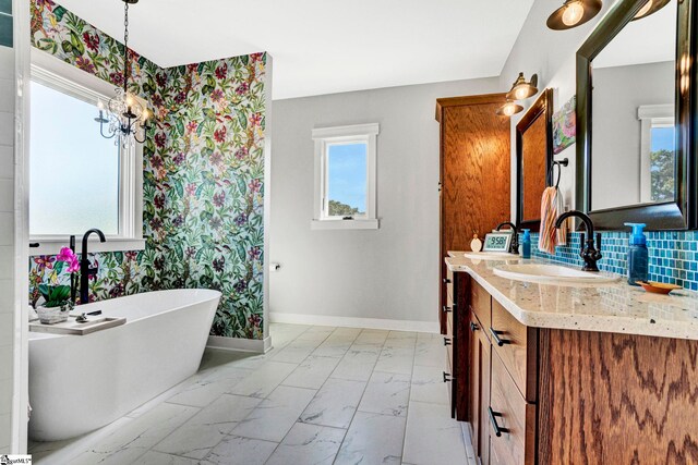 475 Johnson Rd, Easley, SC 29642 - full bath with marble look tile flooring, a freestanding bath, baseboards, a chandelier, and vanity